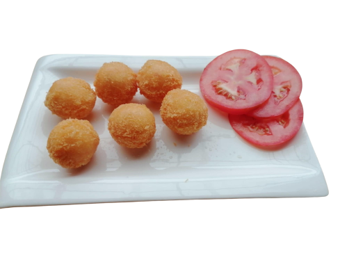 Six golden-fried balls next to three slices of fresh tomato on a white plate.