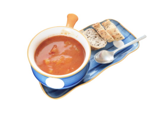 Bowl of tomato soup with bread slices and a spoon on a blue tray.